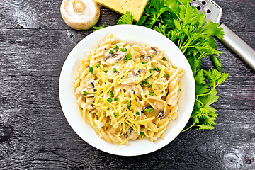 Image showing Fusilli with mushrooms in plate on black board top