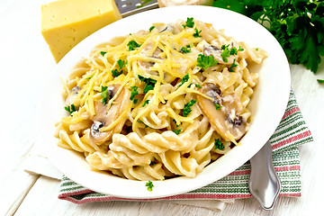 Image showing Fusilli with mushrooms on light board