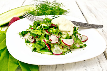 Image showing Salad with radishes and sorrel in plate on light board