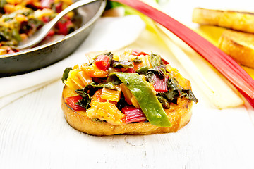 Image showing Bruschetta with leafy beet and orange on table