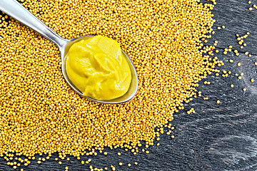 Image showing Sauce mustard in spoon on seeds top
