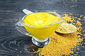 Image showing Sauce mustard in sauceboat with powder on board