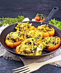 Image showing Pepper stuffed with mushrooms and couscous in pan on burlap