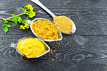 Image showing Sauce mustard in two sauceboats with flower on board top