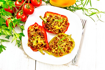 Image showing Pepper stuffed with meat and couscous in plate on light board to