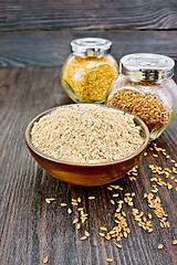 Image showing Flour linen in bowl with seeds in jars on table