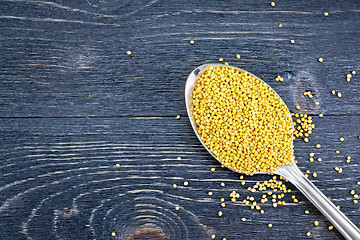 Image showing Mustard seeds in metal spoon on board top