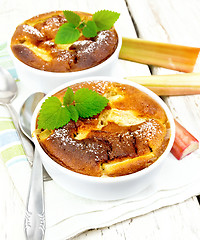 Image showing Klafuti with rhubarb in bowl on wooden table