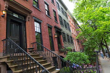 Image showing Row of old brownstone buildings along an empty sidewalk block in the Greenwich Village neighborhood of Manhattan, New York City NYC