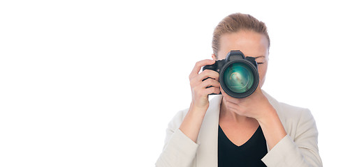 Image showing Female photographer takes images with dslr camera