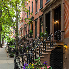 Image showing Row of old brownstone buildings along an empty sidewalk block in the Greenwich Village neighborhood of Manhattan, New York City NYC