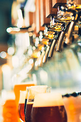 Image showing Beer taps in a pub