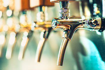 Image showing Beer taps in a pub