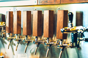 Image showing Beer taps in a pub