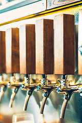 Image showing Beer taps in a pub