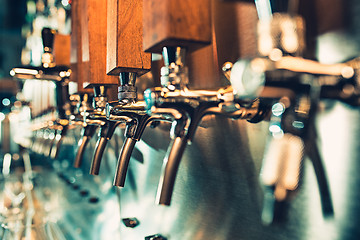 Image showing Beer taps in a pub