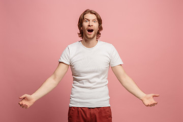 Image showing The young attractive man looking suprised isolated on blue