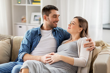 Image showing man hugging pregnant woman at home