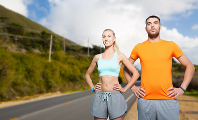 Image showing happy couple doing sports over big sur hills