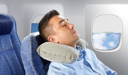 Image showing man sleeping in plane with cervical neck pillow