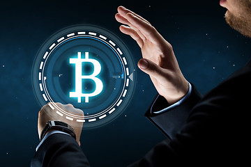 Image showing businessman with smart watch and bitcoin hologram