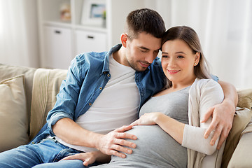 Image showing man hugging pregnant woman at home