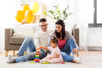 Image showing baby girl with parents playing with pyramid toy