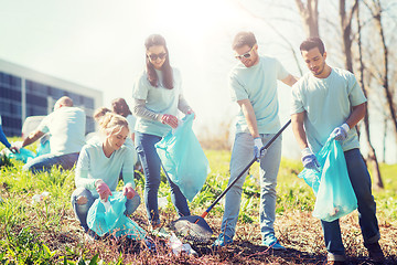 Image showing volunteers with garbage bags cleaning park area