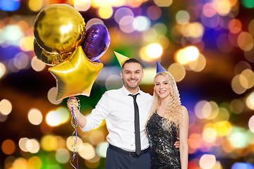 Image showing happy couple with balloons over party lights