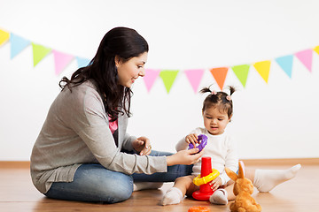 Image showing mother and baby daughter playing with pyramid toy