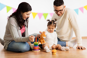 Image showing baby girl with parents playing with toy rabbit