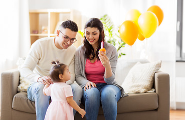 Image showing baby girl with parents at home birthday party