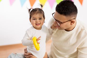 Image showing happy father and little daughter at birthday party