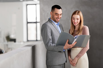 Image showing businesswoman and businessman with folder