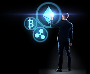 Image showing buisnessman with cryptocurrency holograms