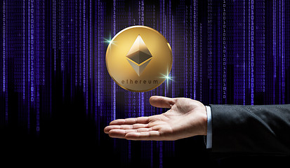 Image showing businessman hand with ethereum over binary code