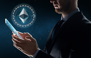 Image showing businessman with tablet pc and ethereum hologram