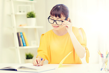 Image showing happy asian young woman student learning at home