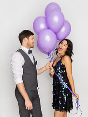 Image showing happy couple with ultra violet balloons at party