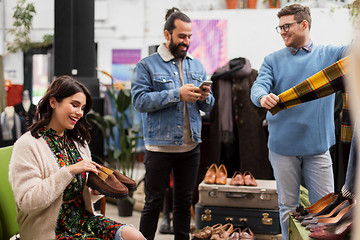 Image showing friends choosing clothes at vintage clothing store