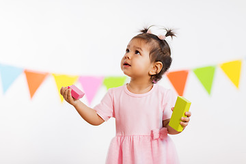 Image showing happy baby girl with toy blocks at birthday party