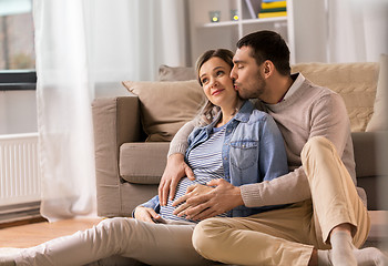 Image showing man kissing and hugging pregnant woman at home