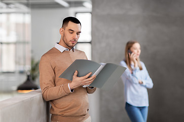 Image showing male office worker with folder