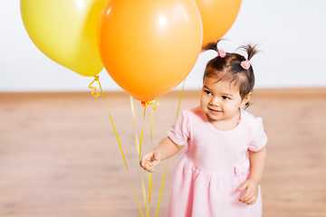 Image showing happy baby girl with balloons on birthday party