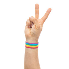 Image showing hand with gay pride rainbow wristband make peace