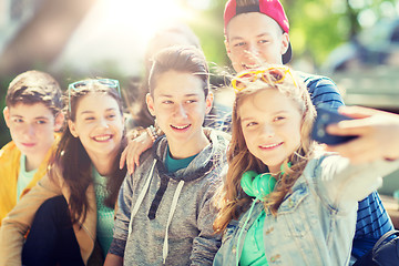 Image showing happy teenage students taking selfie by smartphone