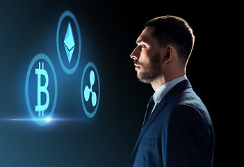 Image showing buisnessman looking at cryptocurrency icons