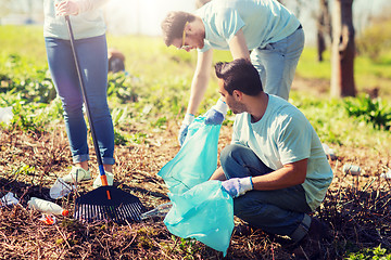 Image showing volunteers with garbage bags cleaning park area