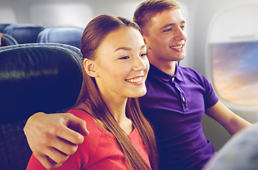 Image showing happy couple travelling by plane