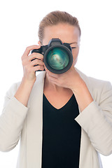 Image showing Female photographer takes images with dslr camera